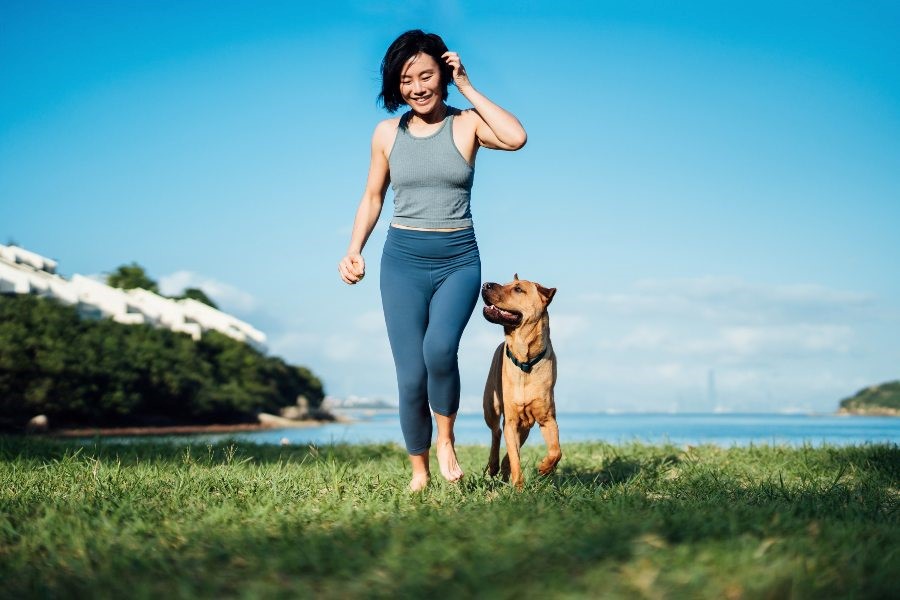 A woman running with her dog